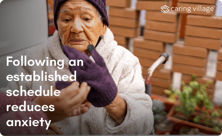 A person helping an elderly woman put on a glove
