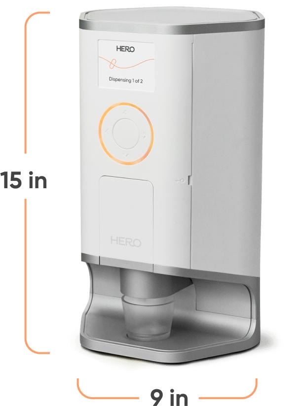 Hero automatic medication dispenser, white countertop device shown with its 15-by-9-inch size guide